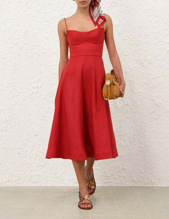 Model wearing the Rebellion Tuck Midi Dress in Red, showcasing its flattering fit and elegant movement.