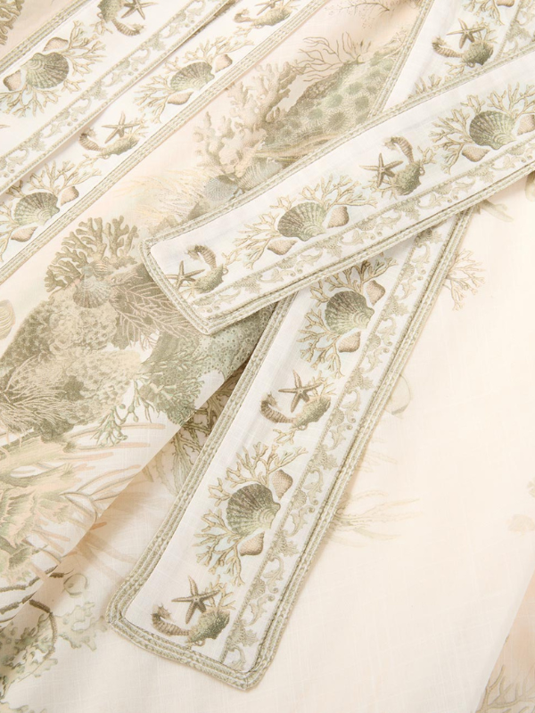 Wanderlust Wrap Midi Dress in Khaki Toile displayed on a mannequin, emphasizing its elegant design and color.