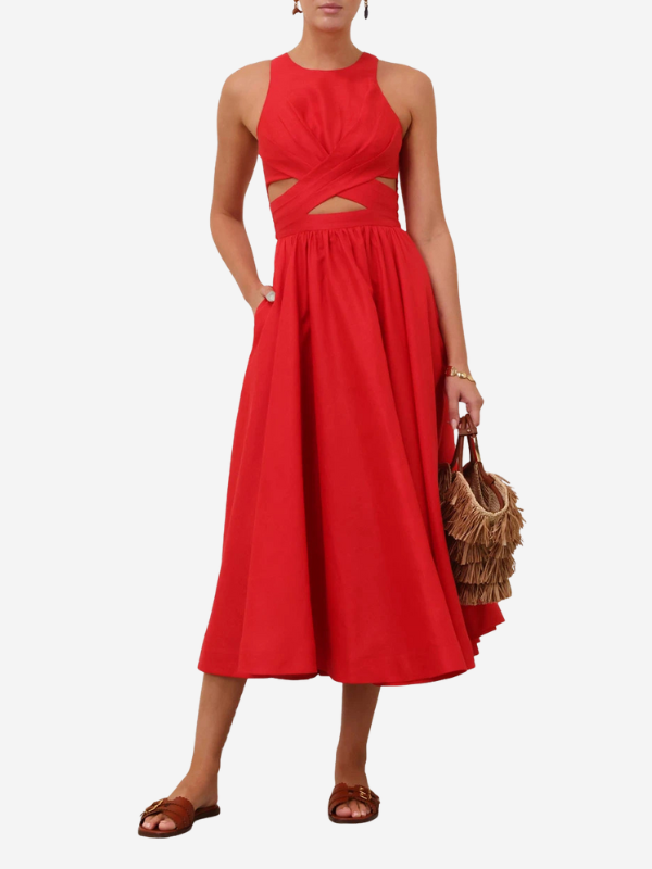 Model wearing the Patience Midi Dress in Dark Red at a resort setting.