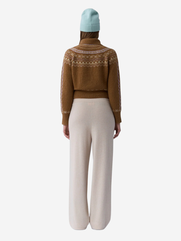 Flat lay of the Cloud Chalet Cardigan in Almco, featuring its crafted details and warm color tones.