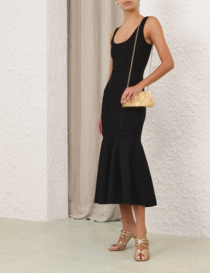 Elegant scene featuring the Hypnotic Sculptural Midi Dress in Black against a neutral background.