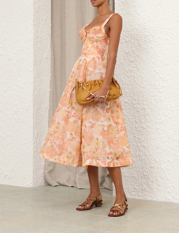 Back view of the Rebellion Drape Midi Dress in Golden Bloom, demonstrating its chic design.