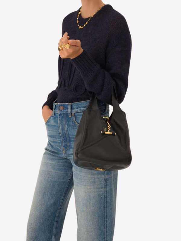 Close-up of the Chloé Small Balloon Bag in Black, featuring a signature Horse Medal on the base.