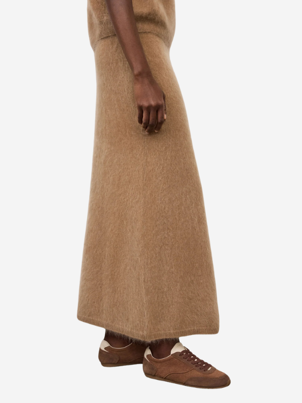 The Asta Skirt in Toffee laid flat, highlighting the beautiful toffee color and elegant knee-length cut.