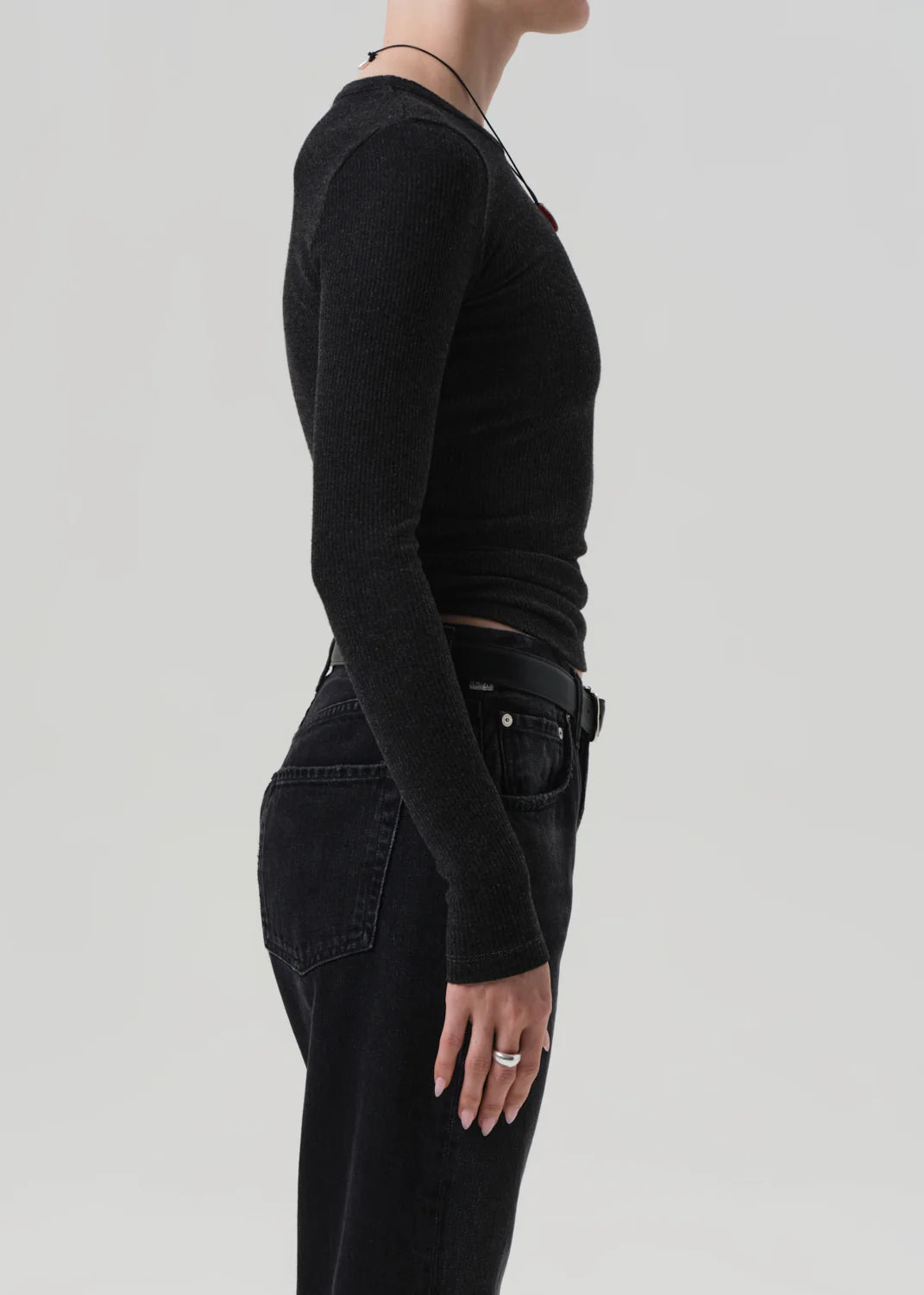 Bina Crewneck in Heather Charcoal styled with denim, perfect for layering or wearing solo.