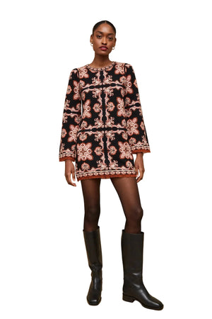 Close-up of the Fritz Dress in Black Paisley by Cara Cara, highlighting the contrast fringe trim and long sleeves.