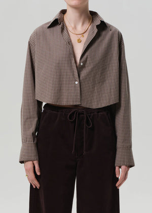 Model wearing the Ana Cropped Shirt in Heritage Plaid, styled with high-rise denim for a trendy look.