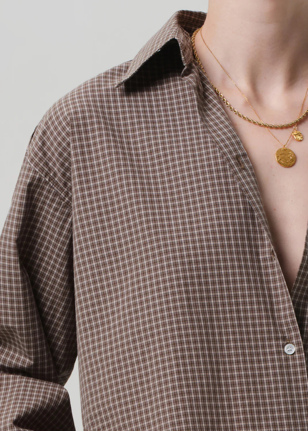 Flat lay of the Ana Cropped Shirt in Heritage Plaid paired with relaxed trousers, perfect for a casual outfit.