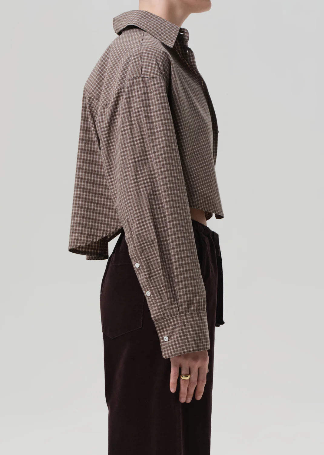 Ana Cropped Shirt in Heritage Plaid displayed on a hanger, emphasizing its pointed collar and airy feel.