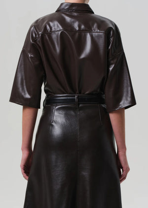 Side profile of the Frances Cropped Cape Button Up in Brown, emphasizing its cropped silhouette and sharp structure.
