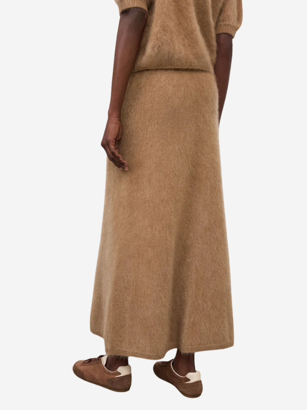 A side profile of the Asta Skirt in Toffee showing off its movement and elegant silhouette.