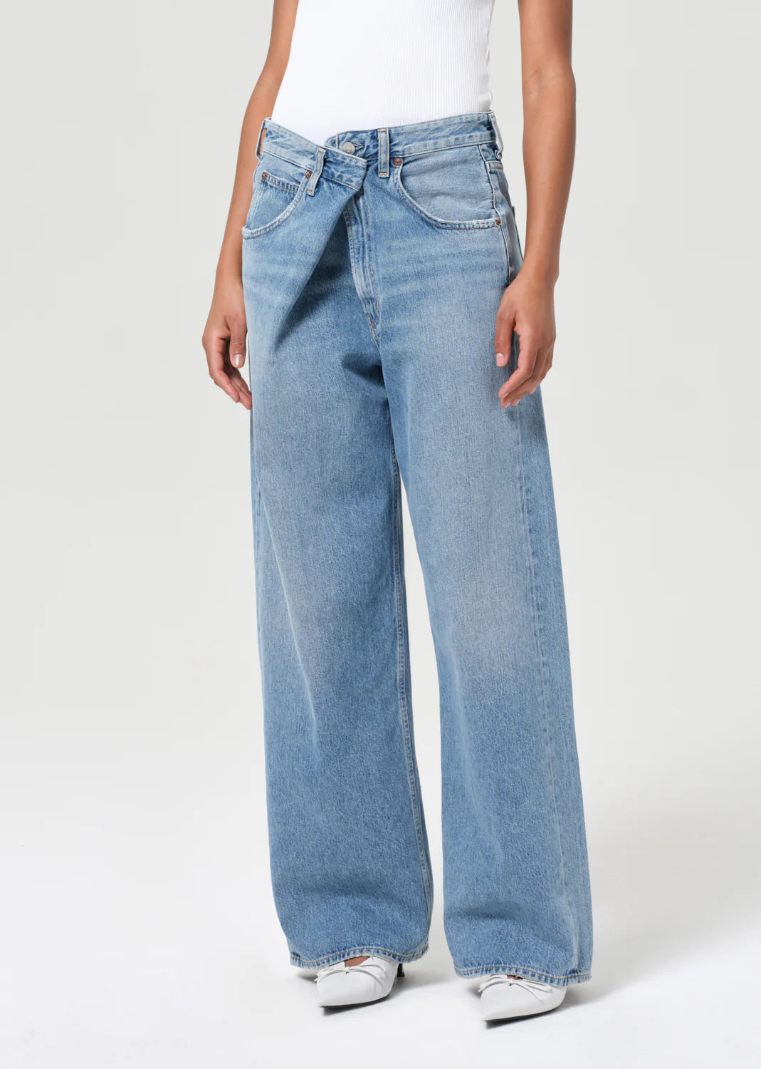 Agolde Vana Fold Jean in Mantra displayed on a hanger, showcasing its relaxed silhouette and bold design