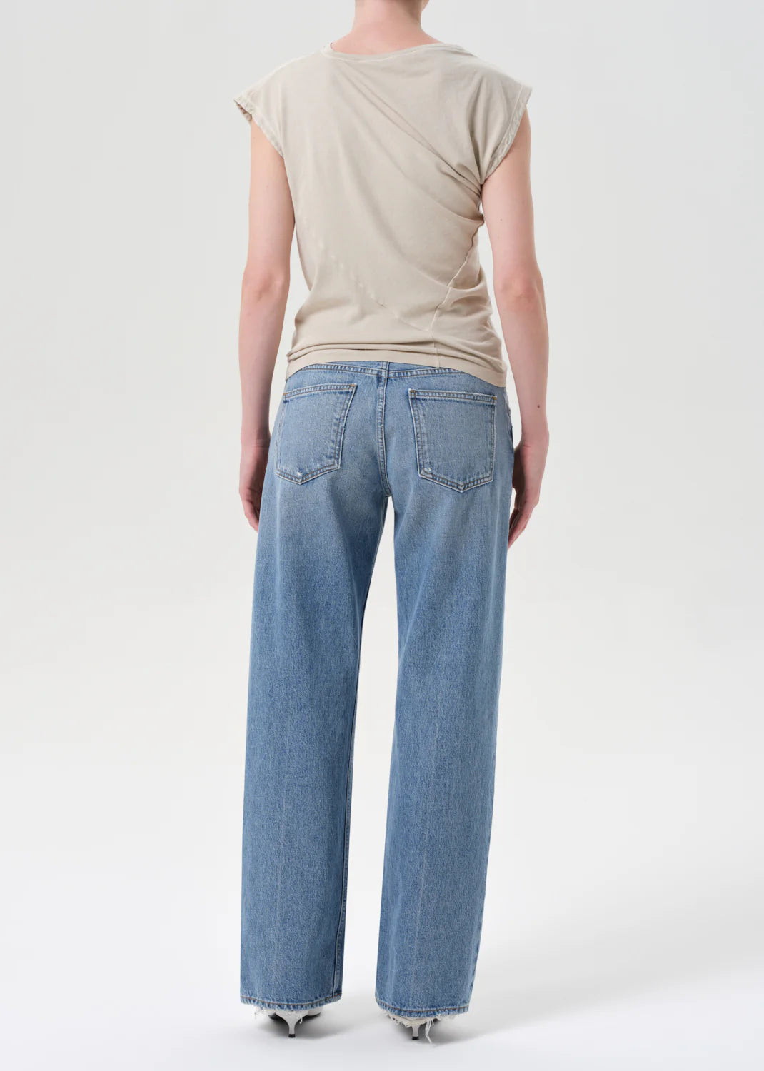 Close-up of the button fly detail on Agolde Low Rise Loose Jeans in Vault, made from 100% regenerative cotton.