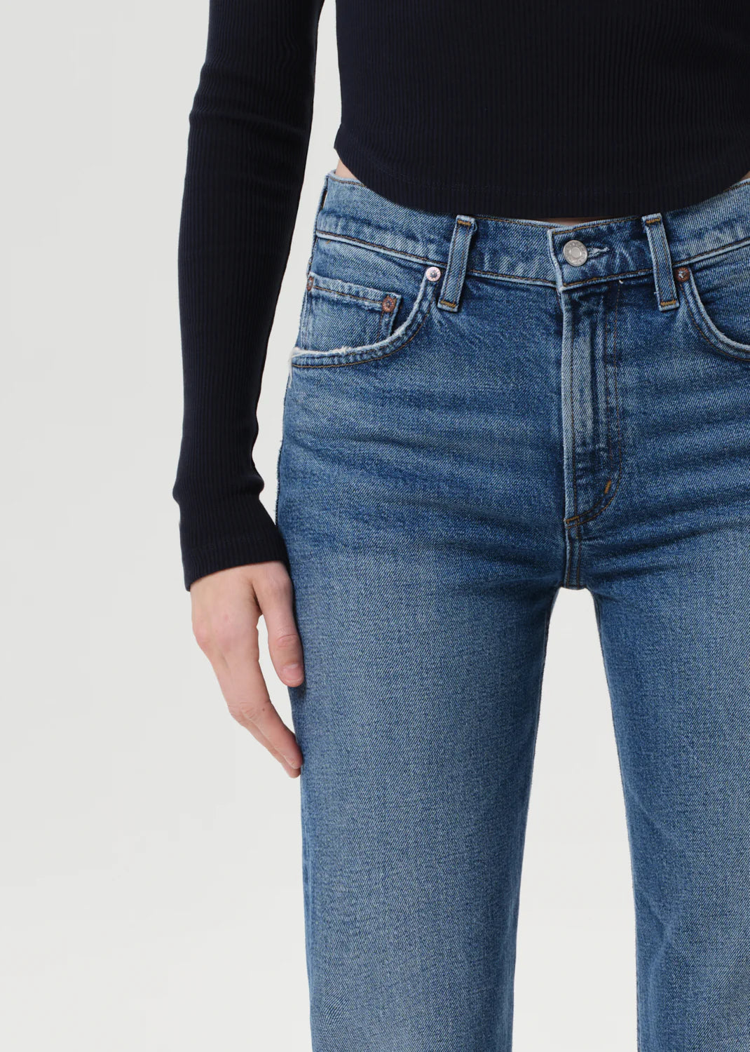 Flat lay of Agolde Kick Boot Jean in Curve on a white background highlighting the zipper fly and leg opening.