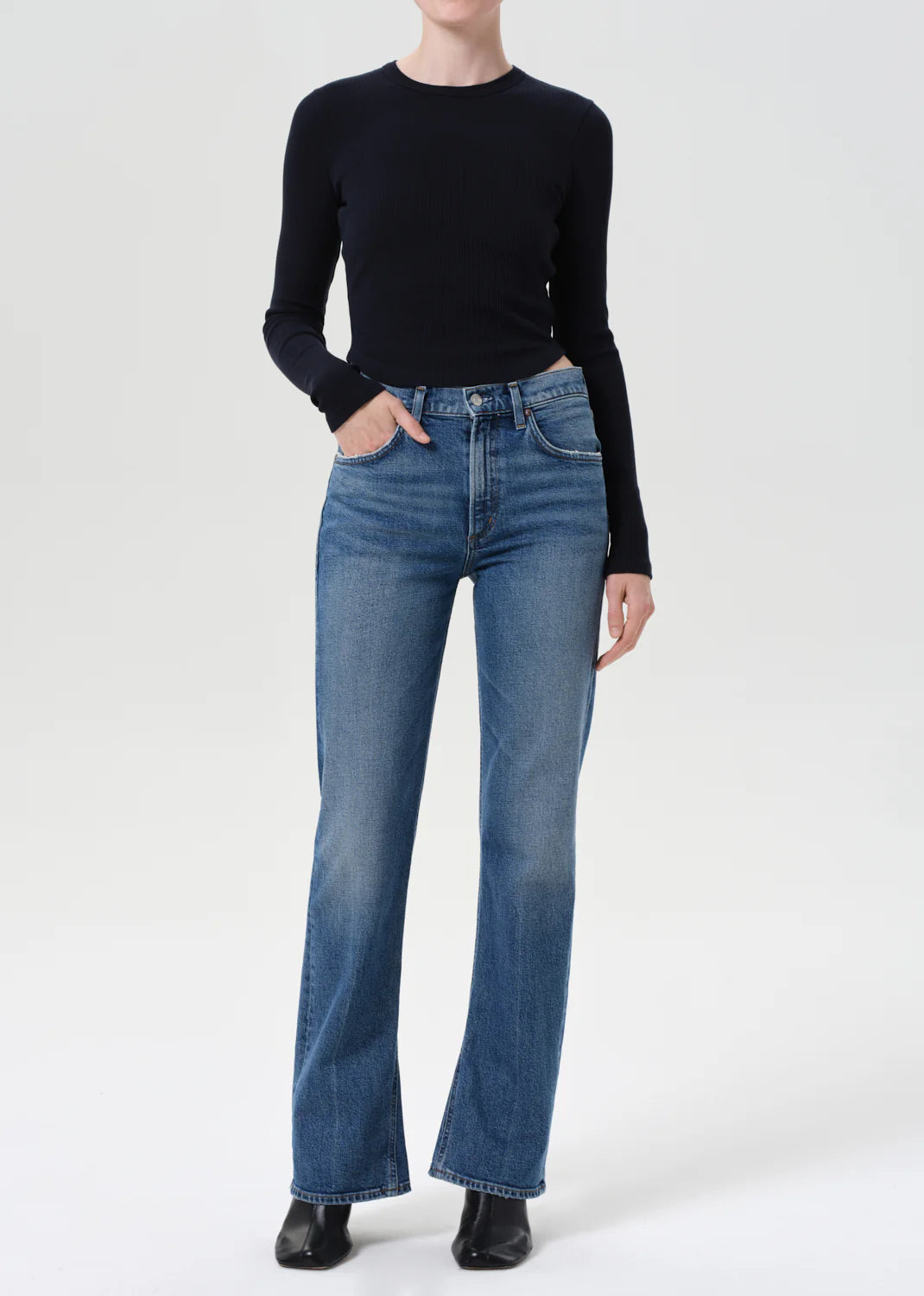Close-up of Agolde Kick Boot Jean in Curve featuring medium indigo wash, worn-in fading, and authentic vintage style.