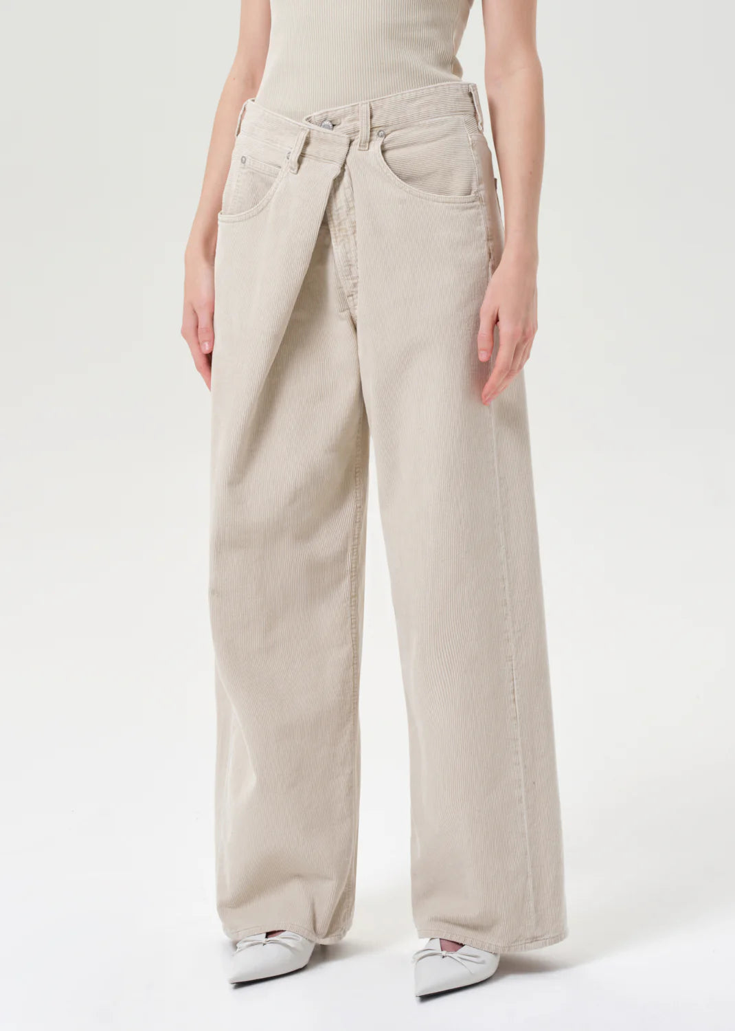 Close-up of Agolde Vana Fold Corduroy in Rice Grass emphasizing the relaxed fit and leg opening.
