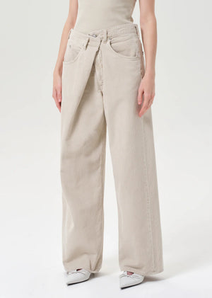 Close-up of Agolde Vana Fold Corduroy in Rice Grass emphasizing the relaxed fit and leg opening.