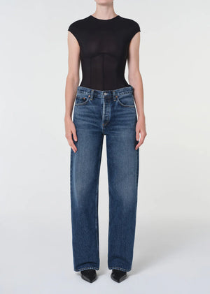 Close-up of Agolde Arc Jean 32" in Shortwave highlighting the button fly closure and rigid regenerative cotton fabric.