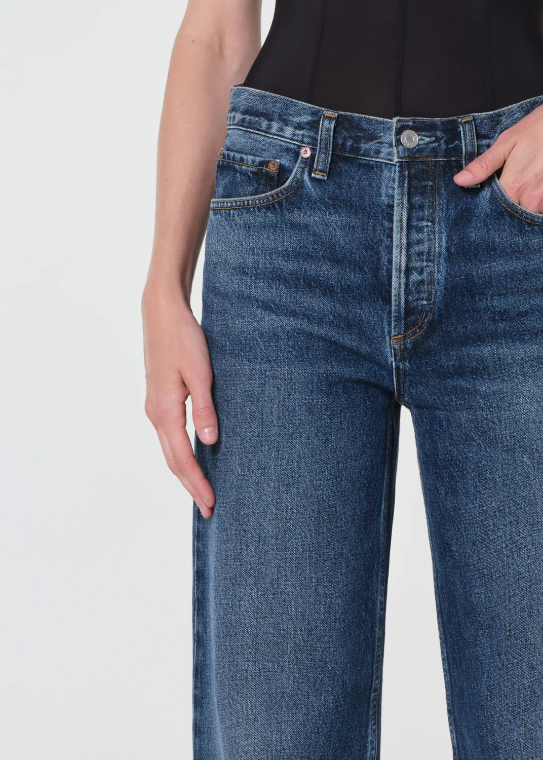 Flat lay of Agolde Arc Jean 32" in Shortwave with details on the 100% regenerative cotton composition.