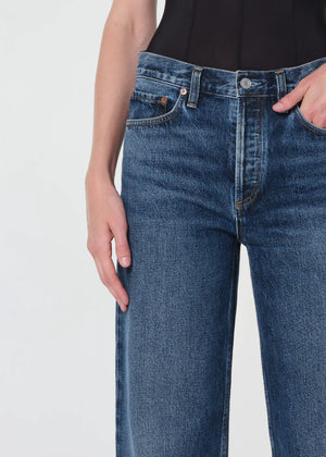 Flat lay of Agolde Arc Jean 32" in Shortwave with details on the 100% regenerative cotton composition.