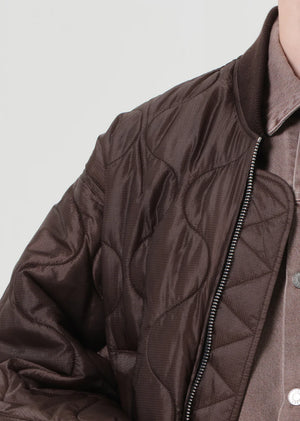 Displaying the Isla Quilted Jacket in Bourbon with highlighted details of 100% polyamide shell and polyester filling.