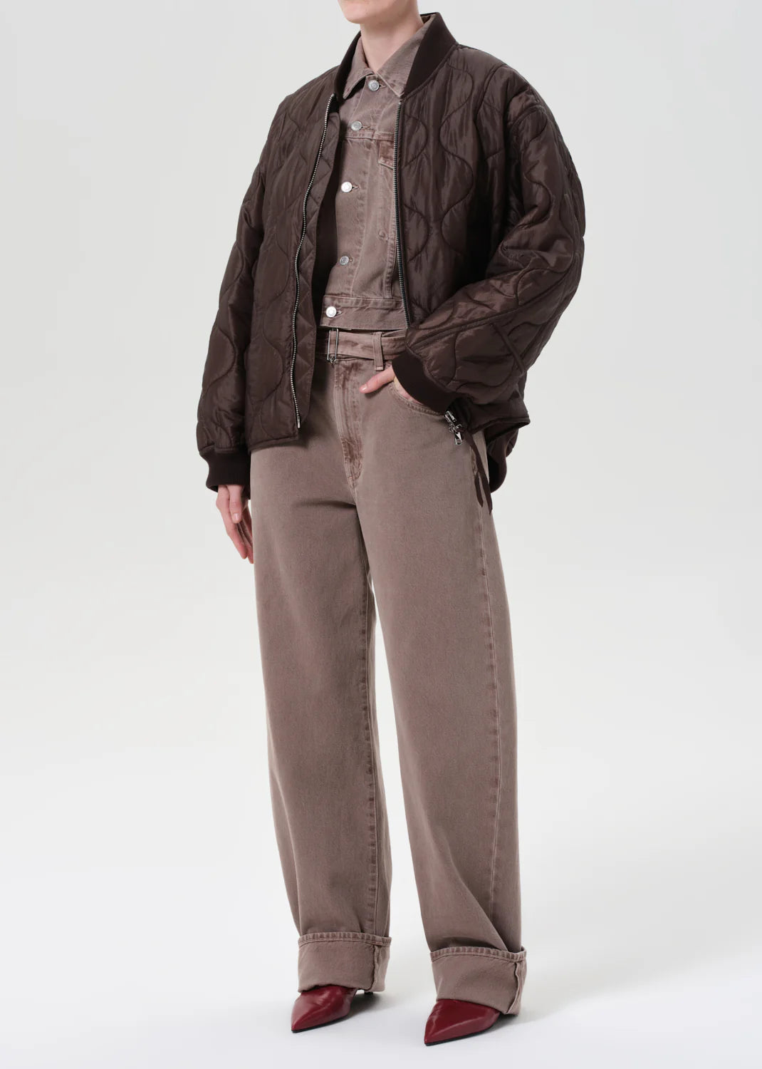 Close-up of Agolde's Isla Quilted Jacket in Bourbon highlighting the soft nylon fabric and rich dark chocolate color.