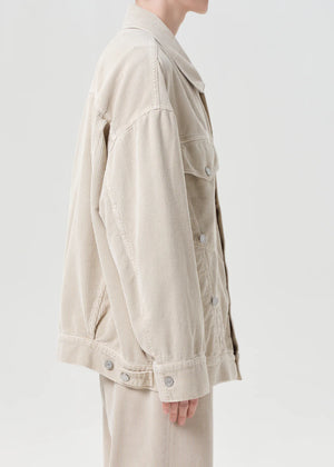 The Reworked Wayne Jacket in Rice Grass from Agolde, styled with denim for a trendy, tonal look ideal for casual outings.