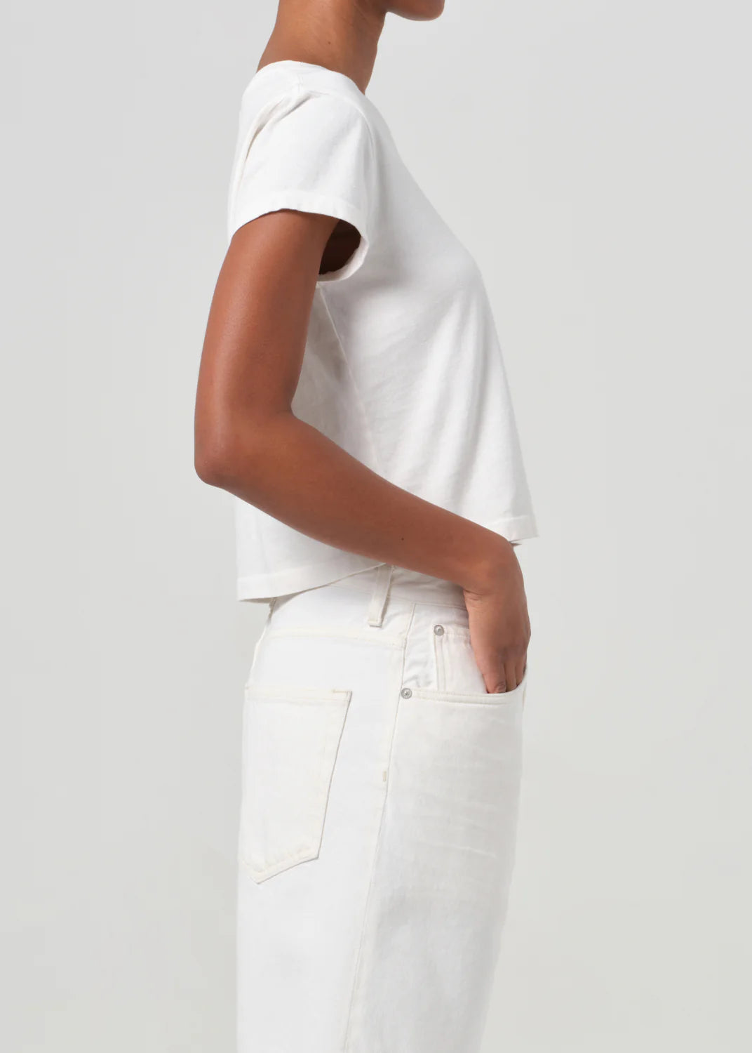 Adine Shrunken Tee in White Ash displayed on a hanger, emphasizing its versatile design for layering.