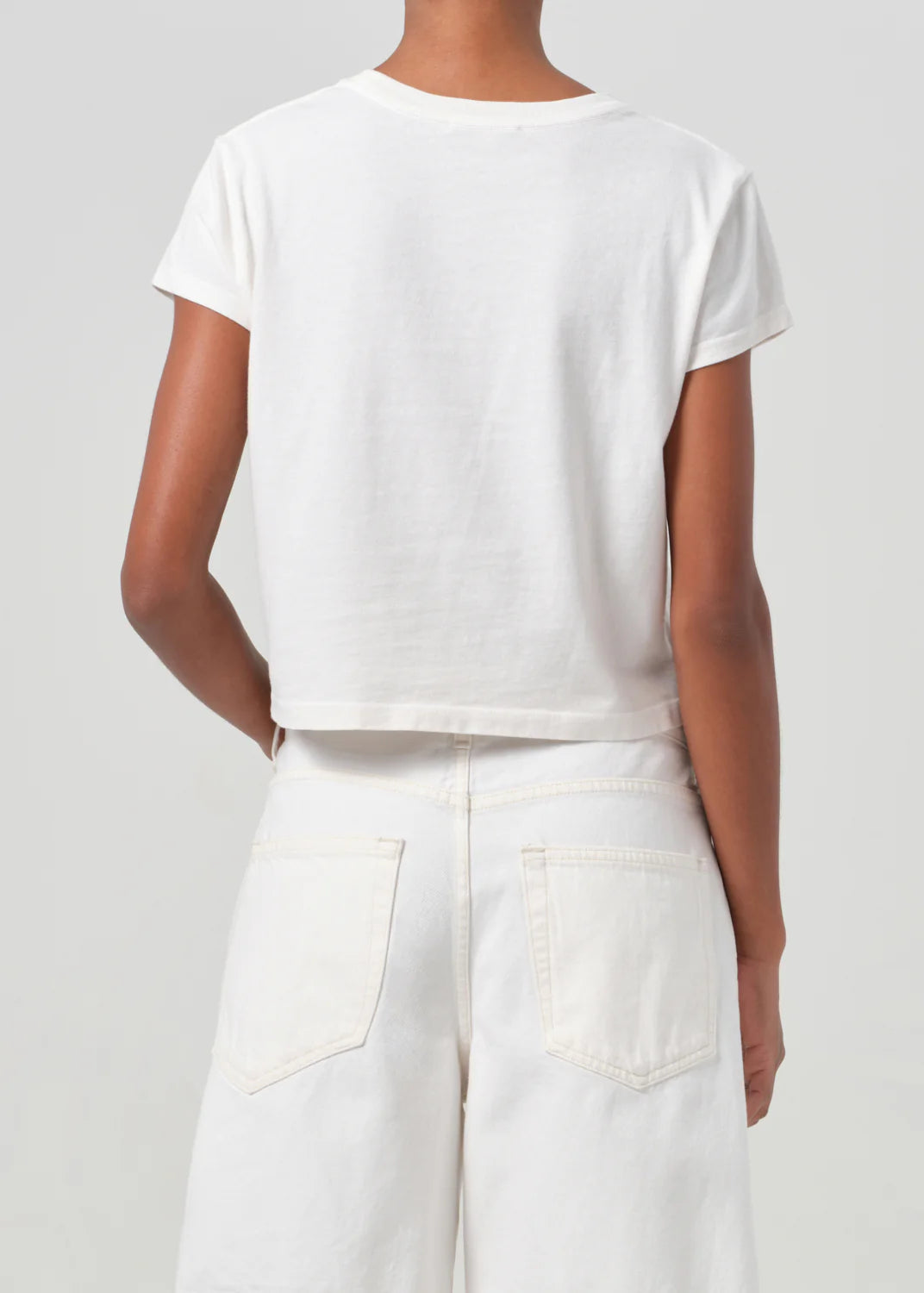 Side view of Agolde's Adine Shrunken Tee in White Ash, illustrating the flattering silhouette.