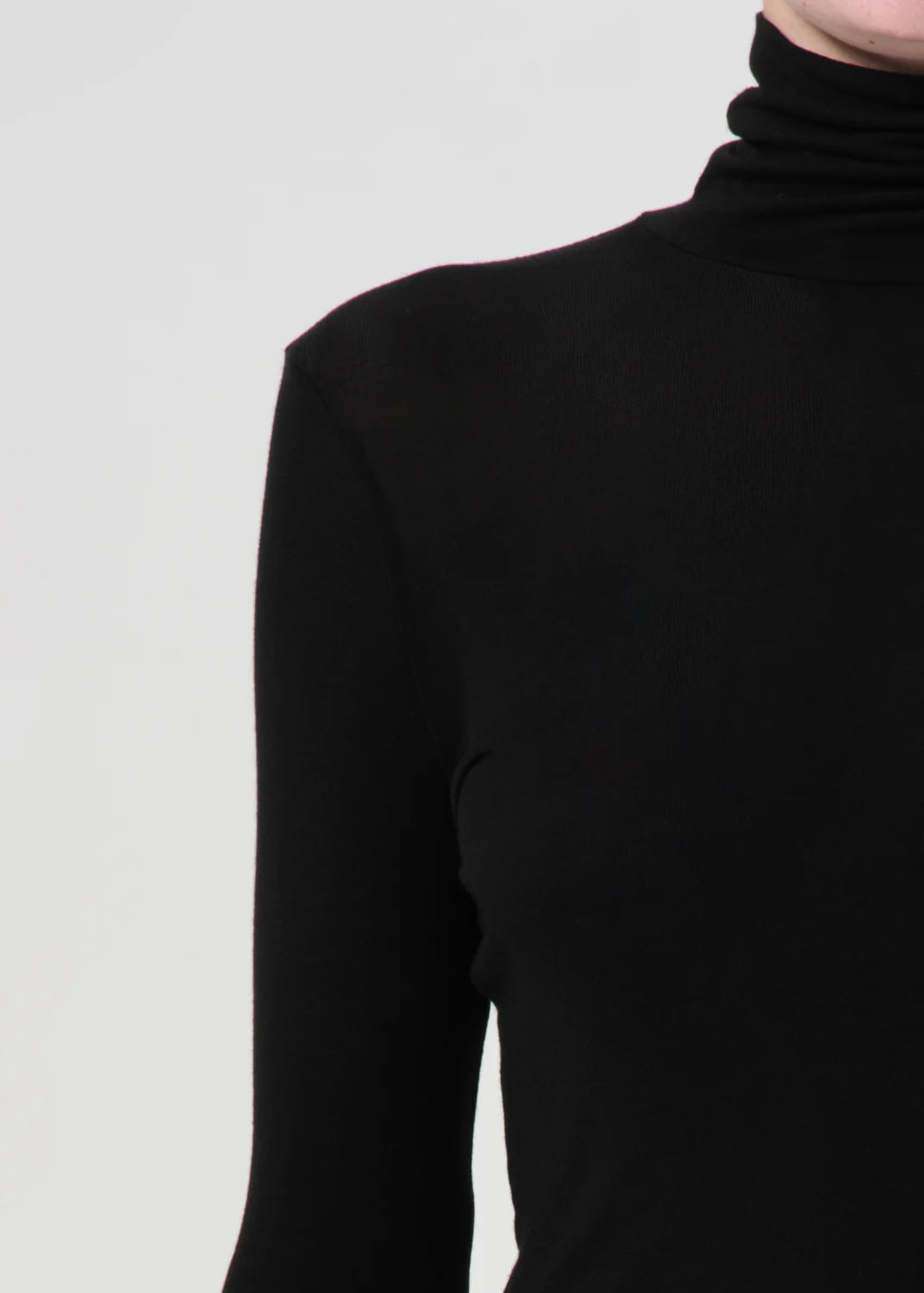 Pascale Turtleneck in Black paired with tailored separates for a versatile styling option.