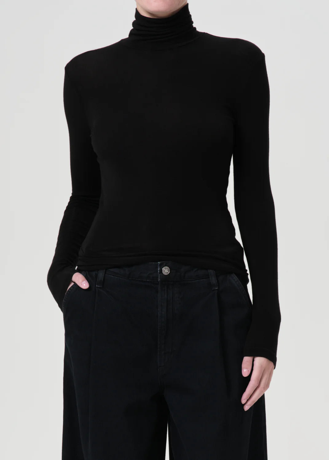 Pascale Turtleneck in Black styled with denim for a chic casual look.