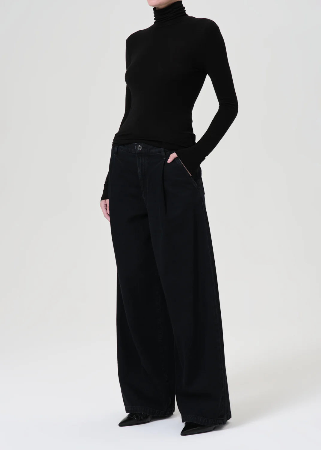 Side view of the Agolde Pascale Turtleneck in Black, designed for versatile styling.