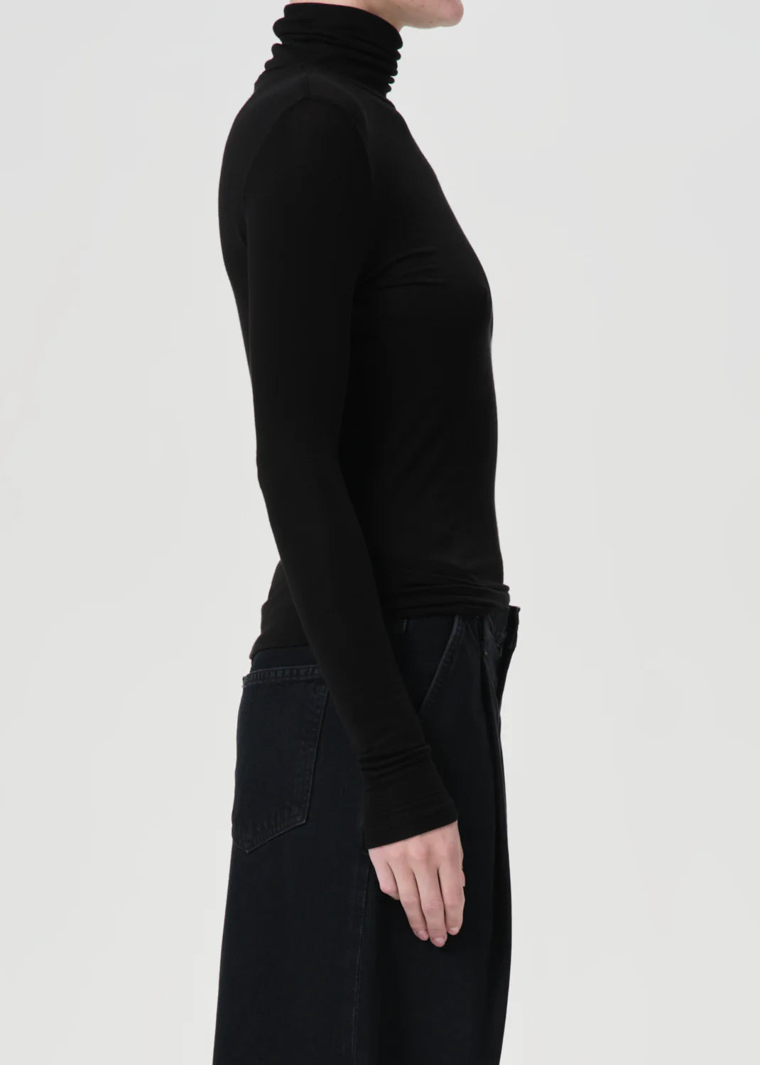 Close-up detail of the fabric texture of the Agolde Pascale Turtleneck in Black.