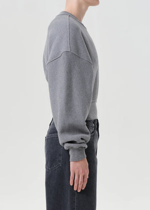Model wearing the Kit Sweatshirt in Heather Grey, styled with denim for a casual look.