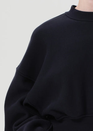 Lifestyle shot of the Kit Sweatshirt in Mirage by Agolde, perfect for layered outfits and casual occasions.