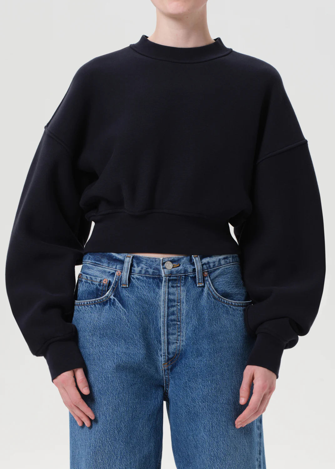 Model wearing the Kit Sweatshirt in Mirage paired with oversized trousers for a stylish off-duty look.