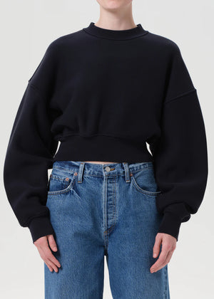 Model wearing the Kit Sweatshirt in Mirage paired with oversized trousers for a stylish off-duty look.