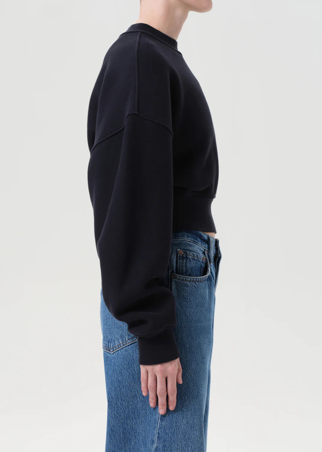 Back view of the Kit Sweatshirt in Mirage, highlighting the cinched shape and elasticated hem.