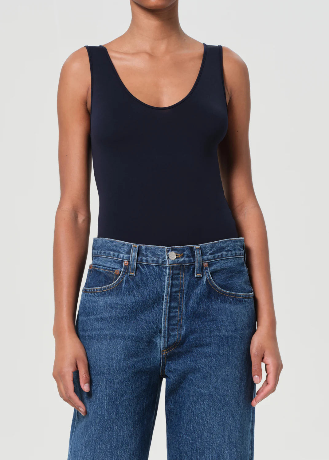 Model wearing the Agolde Tora Bodysuit in Mirage, highlighting its flattering body-contouring fit.