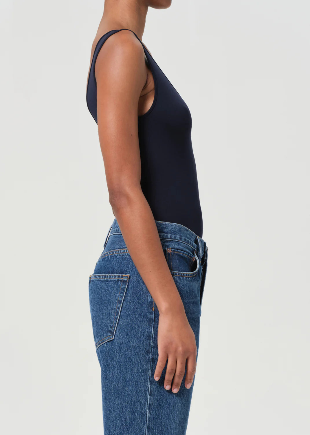 Agolde Tora Bodysuit in Mirage displayed with denim for a trendy layered look.