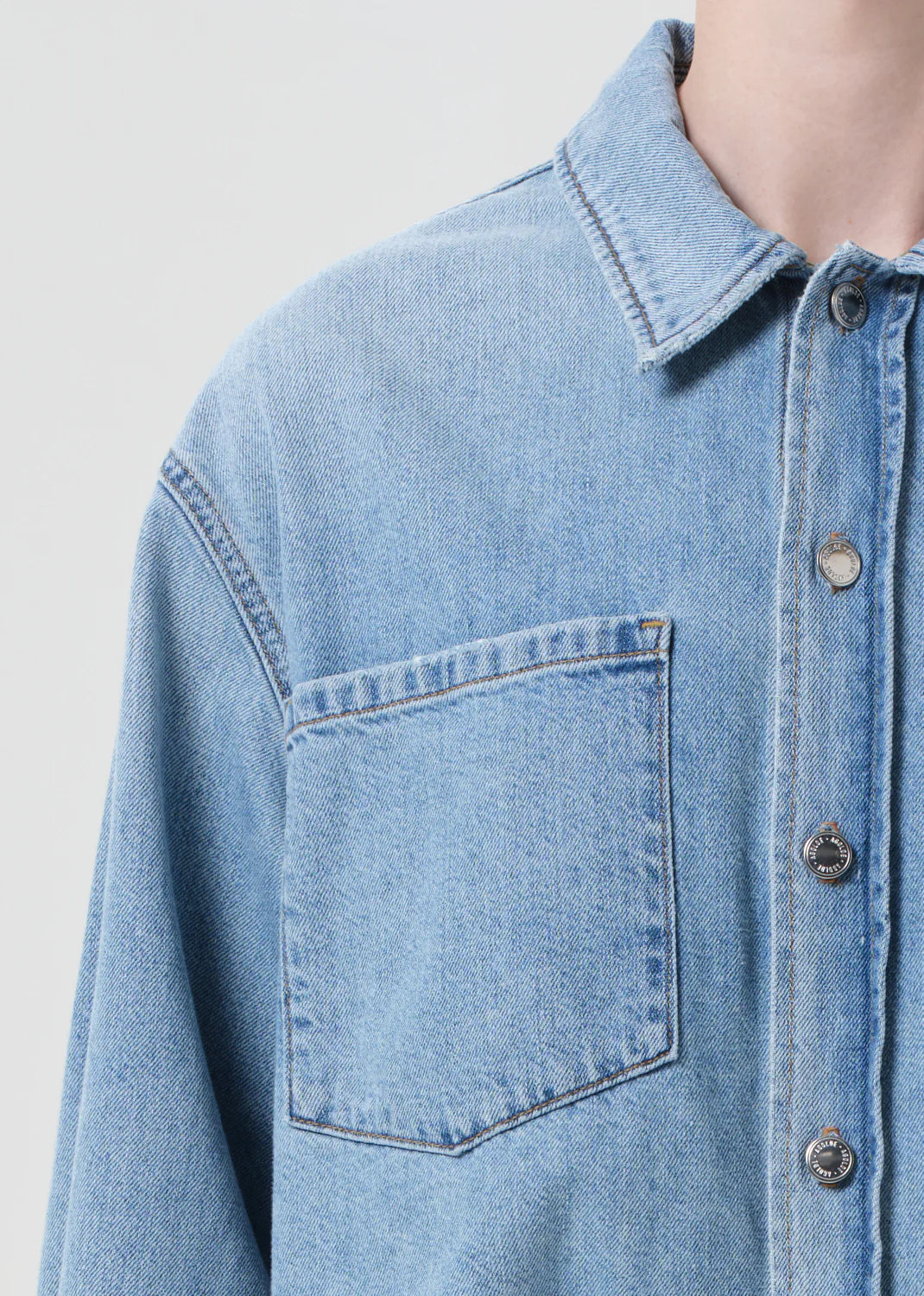 Lifestyle shot of the Juna Shirt in Interval, styled with tonal jeans for a cohesive denim outfit.