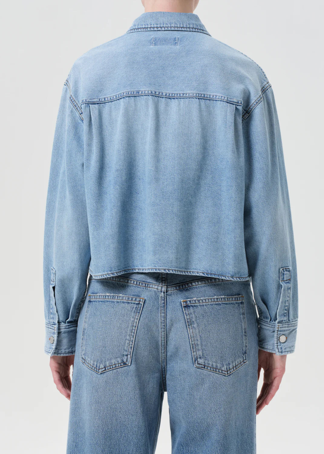 Flat lay of the Juna Shirt in Interval by Agolde, showcasing its soft, non-stretch denim and patch pockets.