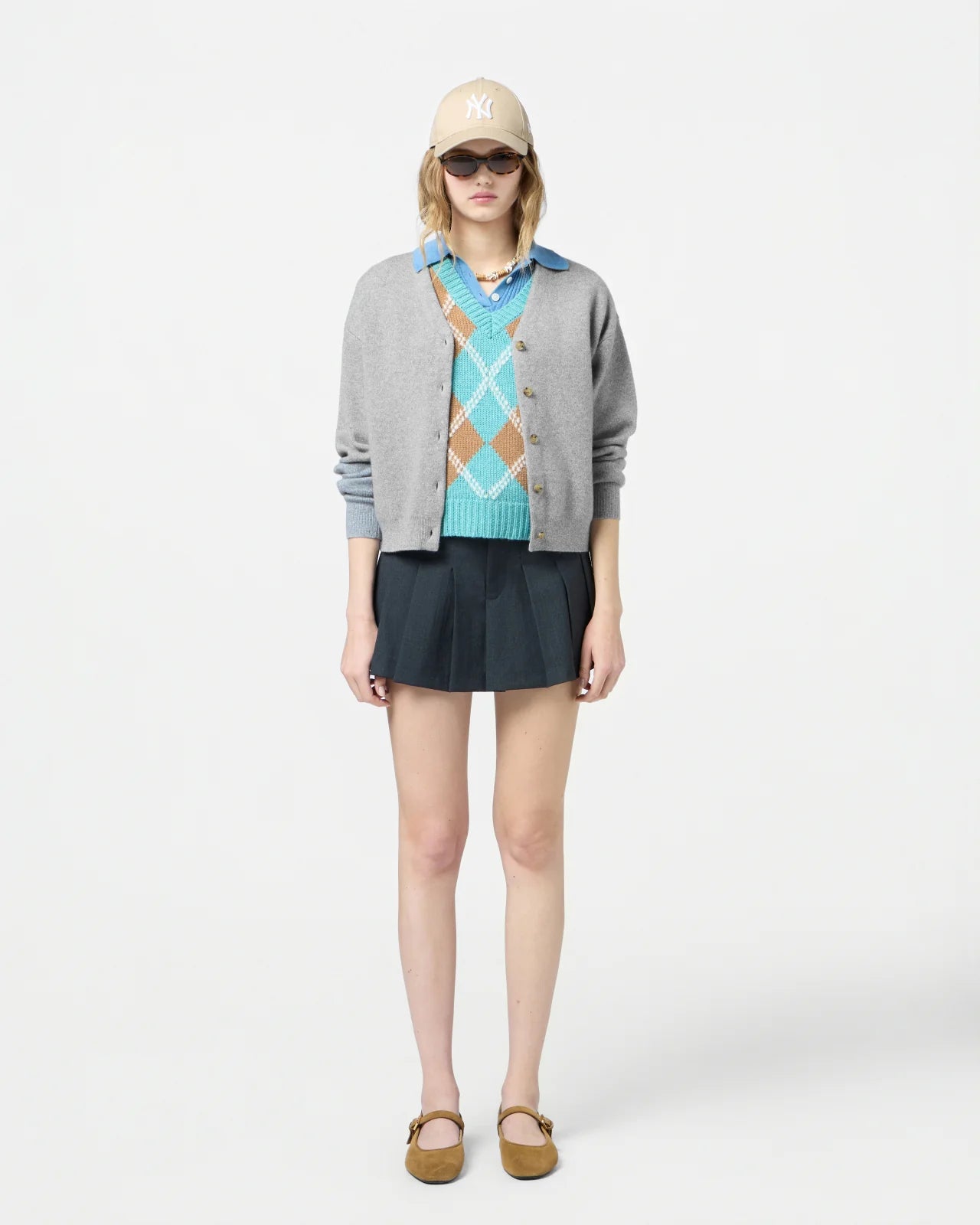 Close-up of the Collegiate Cardigan in Heather Grey, showcasing the cashmere fabric and side slits.