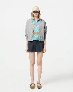 Close-up of the Collegiate Cardigan in Heather Grey, showcasing the cashmere fabric and side slits.
