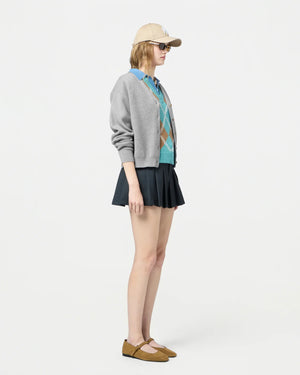 Model wearing the Collegiate Cardigan in Heather Grey styled with casual jeans, perfect for a relaxed look.