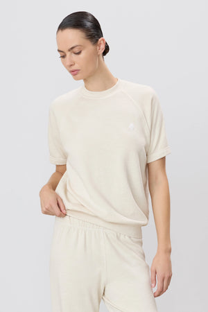 Éterne's Short Sleeve Raglan Sweatshirt in Bone, displaying a chic and casual look, made from soft French terry for a lightweight feel, emphasizing short sleeve sweatshirt style.