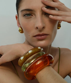 Model wearing Mini Arp Earrings in Studded Gold, perfect for both casual and formal occasions.
