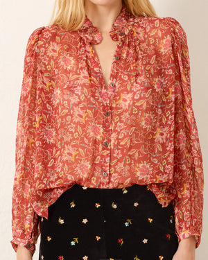 Flat lay of the Annabel Shirt in Sunset Ember, featuring its vibrant color and chic ruffled collar