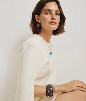 Close-up view of the Ridge Cuff in Clear, highlighting its elegant clear resin material and stylish shape, designed by Lizzie Fortunato.