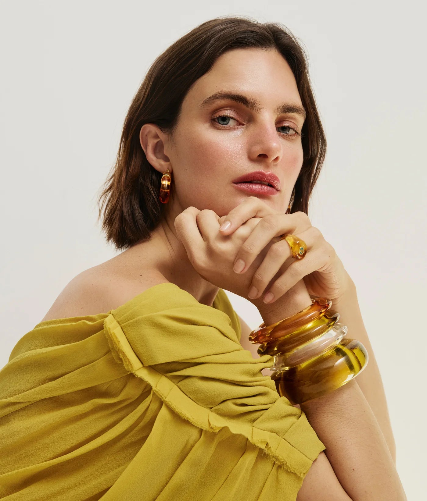 Model wearing the Arc Cuff in Apple by Lizzie Fortunato, highlighting its trendy look on the forearm.